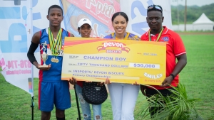 Far left, St John&#039;s Primary student Perez Pearson accepts the symbolic cheque for finishing as Champion Boy in the Central Championships from Sherene Bryan, brand manager Devon Biscuits (second right). Joining in the occasion is second from left, Pearson&#039;s mother Tamara Woodhouse and his coach Jermaine Miller.