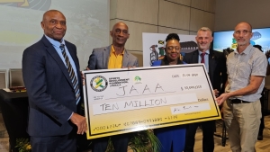 (l-r) Chairman of the Local Organizing Committee Ludlow Watts, JAAA President Garth Gayle, Minister Olivia Grange, German Ambassador to Jamaica Jan Hendrik van Thiel and General Manager of the Sports Development Foundation Alan Beckford during the handover of the cheque for Jamaican $10million to the inaugural Jamaica Athletics Invitational on Thursday.  The ceremonial presentation occurred at the AC Hotel in Kingston. The JAI is set for May 11 at the National Stadium in Kingston.