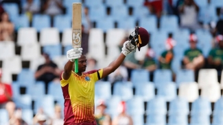 Johnson Charles raises his bat after bringing up his record-breaking 39-ball hundred in the second T20I against South Africa on Sunday.