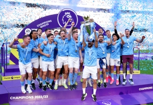 Manchester City players and fans celebrate step one of the treble