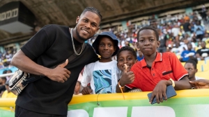 Reggae Boyz goalkeeper and captain Andre Blake poses with some youngsters at the JPL final at the National Stadium in Kingston on Sunday.