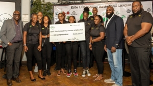 Members of the Jamaica Women&#039;s Basketball team receiving a cheque from PHASE 1 CEO Wayne Dawkins (second right) on Saturday. Left is Paulton Gordon, President of the Jamaica Basketball Association.