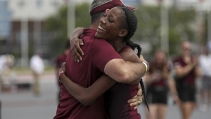 Lamara Distin hugs coach Pat Henry after soaring to a world-leading 1.97m in Texas on Saturday
