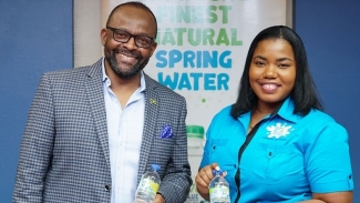 Donovan White and Pettrine Harris at the recent signing of the sponsorship agreement between Professional Football Jamaica Limited and 876 Spring Water.