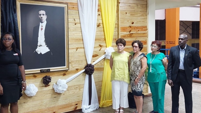 The portrait of GC Foster unveiled with his granddaughters (l-r) Heather Chin, Debbie Jardine, and Andrea Roberts looking on. Vice-Principal Gibbs Mills stands in support with the cousins. Left is Chantalle Nash, Product Manager for Online Betting and Gaming at Anybet, the primary sponsor of the 50 Days Afire book project. 