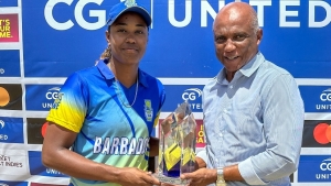 Mr. Dennis Phillip- President St. Kitts Cricket Association presents CG United Women&#039;s Super50 Cup trophy to Barbados captain Hayley Matthews