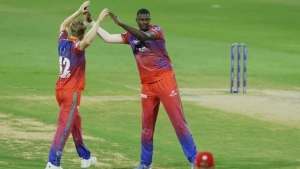 Jason Holder (right) celebrates a wicket.