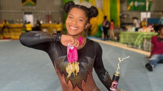 Jamaica&#039;s England-born gymnast Tyesha Mattis displays her many medals won at the National Trials earlier this year.