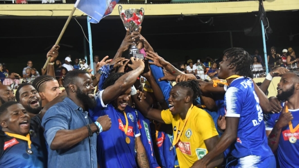 Members of the triumphant Mount Pleasant team celebrate with the Jamaica Premier League trophy after defeating Cavalier 2-1 in the final at Sabina Park on Sunday