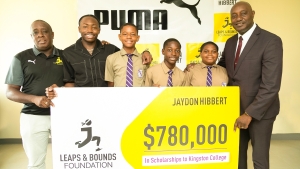 Jaydon Hibbert (2nd left) shares a moment with three scholarship recipients, (left-right) Ricadeen Wilkins, Jehu Green and Joshua Lewin, while KC’s principal Dave Myrie (far right) and Jaydon’s mentor Ricky Martin (far left).