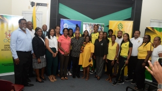 Jamaica&#039;s netballers with JOA President Christopher Samuda, Netball Jamaica President Tricia Robinson and Head Coach Connie Francis along with representatives of Mayberry Investments at the JOA headquarters in Kingston on Monday.