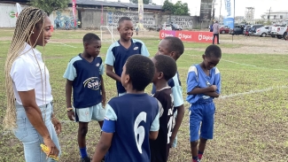 Shelly-Ann Fraser-Pryce speaking to some young fans at Saturday&#039;s opening day of the Pocket Rocket Foundation 6-a-side tournament in Waterhouse.