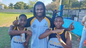 Tapper and two of the athletes from Top Track Academy at their recent media day. Recently appointed head track and field coach at St Andrew High School, Tapper hopes to return the all-girls school to his glory days in athletics.