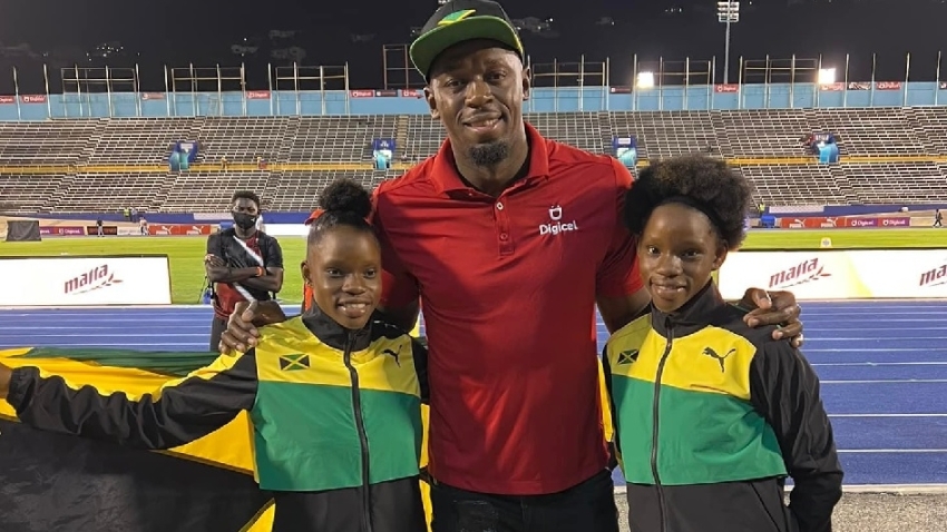 The Clayton twins - Tia (r) and Tina (l) with eight-time Olympic gold medallist and 100m and 200m world record holder Usain Bolt after their 1-2 finish in the 100m at the 49th edition of the Carifta Games at the National Stadium in Kingston in April.