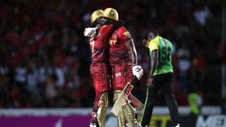 Andre Russell and Akeal Hosein share an embrace after steering TKR to a narrow win over Jamaica Tallawahs at the Brian Lara Stadium on Saturday night.